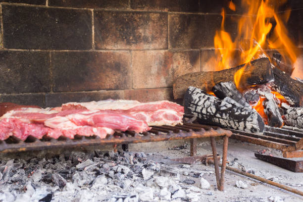istock Barbecue. Meat cuts warming on the embers on an iron grill. Traditional Argentinian bbq. 1319099473