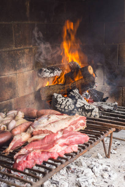 istock Barbecue. Meat cuts warming on the embers on an iron grill. Traditional Argentinian bbq. 1319099513