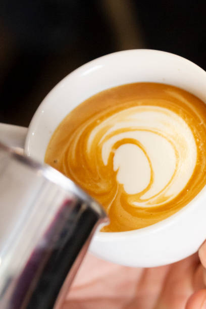 istock barista's hand drawing a picture on the coffee cup 1319100202