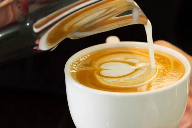 istock barista's hand drawing a picture on the coffee cup 1319100265