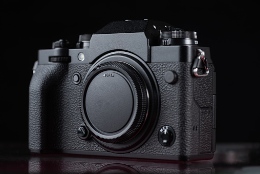 Digital mirrorless camera front view,  concept of photographer