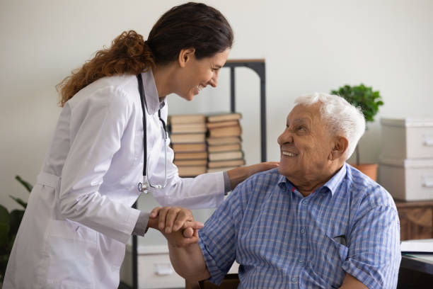 Thankful mature sick man holding nurse hand appreciating for help Thank you doctor. Smiling thankful mature sick man holding young female medic nurse hand appreciating for help support care. Happy woman gp greeting old man patient with recovery good analyses results patient stock pictures, royalty-free photos & images