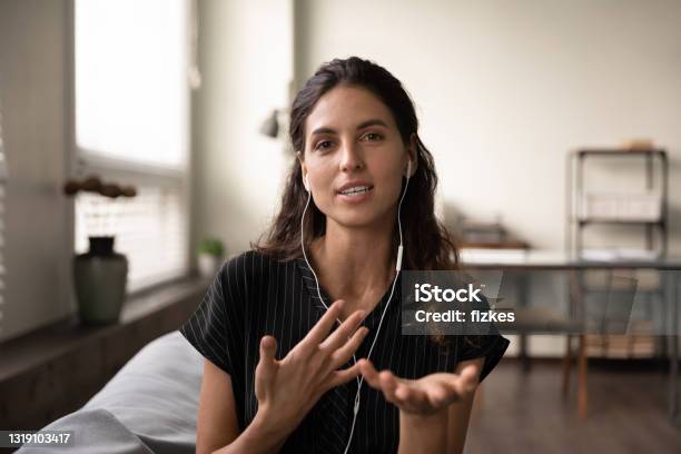 Inspired Female Teacher In Headphones Meet Students Online Give Class Stock Photo - Download Image Now