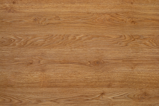 Fine natural wood texture. Top view of light brown wooden table. The board have a strong clear texture of wood without damages. A wood grain pattern featuring even grains of wood running horizontally across the image.