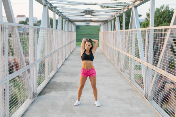 istock Young athlete woman stretching outdoor before a workout 1319107806