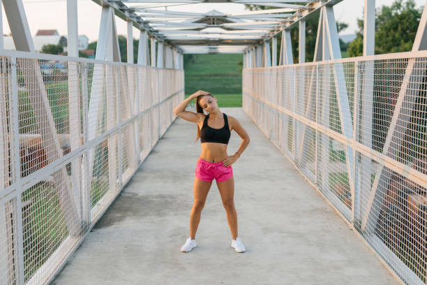 istock Young athlete woman stretching outdoor before a workout 1319109853