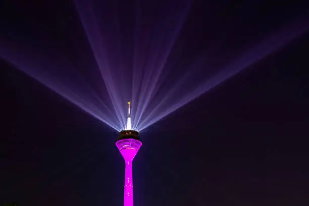 Duesseldorf, Rhine Tower with laser beams of the Rhine Comet during Telekom 2021 5G advertising, Rhine, old town, state parliament at the blue hour