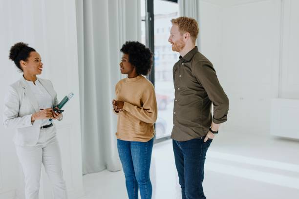 istock Real estate agent showing a new empty apartment to diverse couple 1319111069