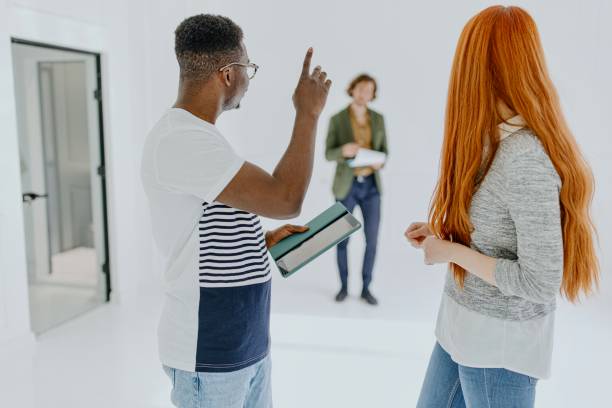 istock Young couple calling real estate agent to come and talk to them 1319112006