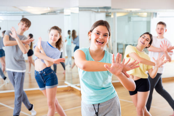 istock Diligent friendly smiling teenagers learn dance movements 1319112366