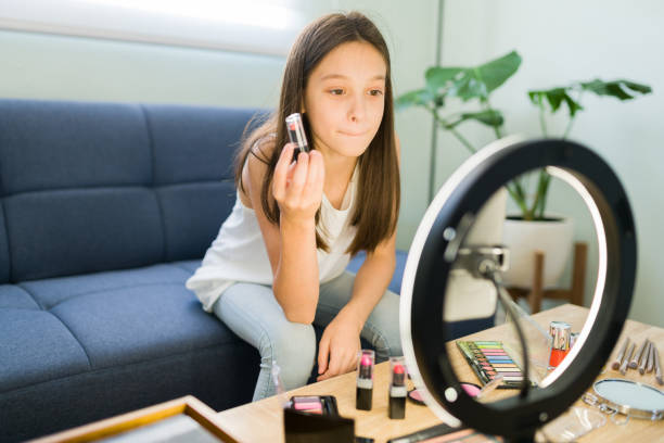 istock Influencer kid putting on a pink lipstick 1319112671