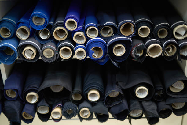 istock Dark fabrics rolls in textile shop. Tailoring concept 1319112730
