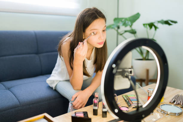 istock Young blogger making a video with a ring light 1319112750