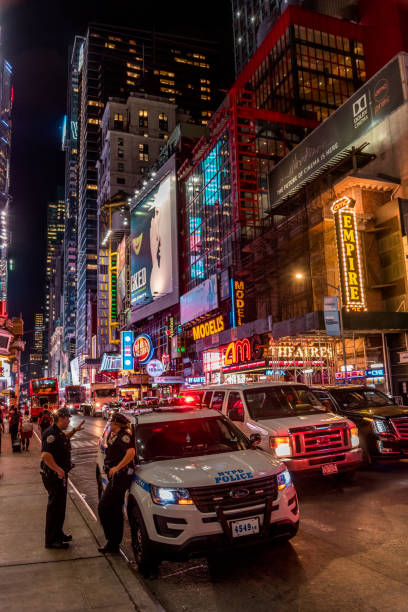 два полицейских ночью в нью- - times square flash стоковые фото и изображения