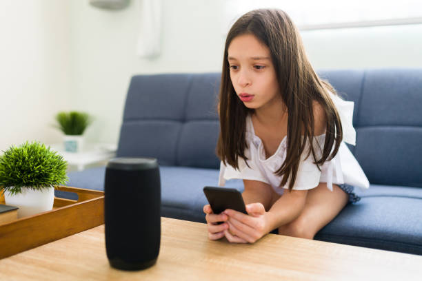 istock Child playing music on a smart speaker at home 1319114279