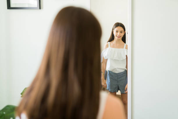 istock Influencer checking her outfit choice in the mirror 1319114314