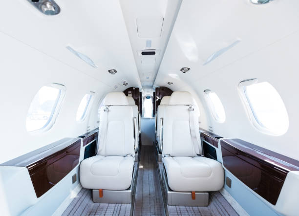 Interior of empty corporate airplane Interior of empty private jet. White seats in corporate airplane. It is representing business travel. private jet interior stock pictures, royalty-free photos & images