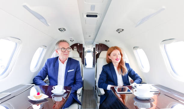 istock Confident colleagues traveling in private jet 1319117221