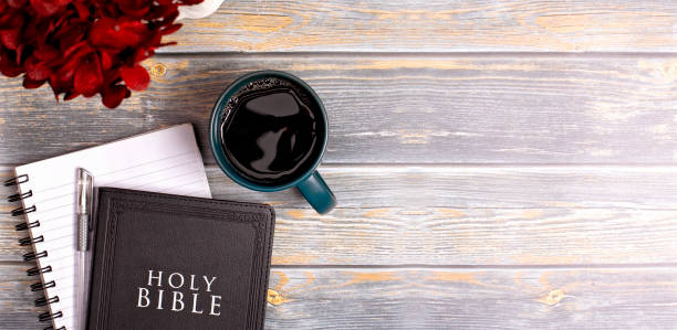 istock Single Bible and Cup of Coffee on a Distressed Wooden Table 1319118764