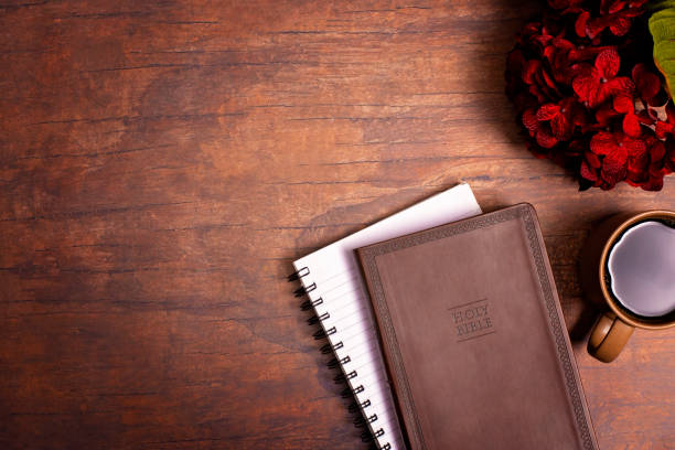 istock Personal Bible Study with Hot Coffee on a Distressed Red Wood Table 1319119280
