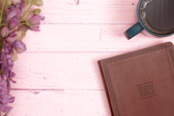 istock Personal Bible Study with a Cup of Hot Coffee on a Pink Table 1319119281
