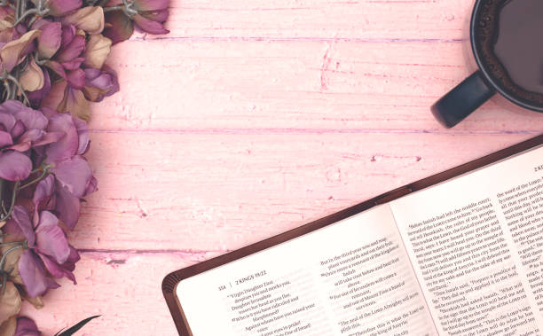 istock Personal Bible Study with a Cup of Hot Coffee on a Pink Table 1319119298