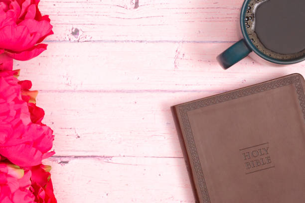 istock Personal Bible Study with a Cup of Hot Coffee on a Pink Table 1319119307