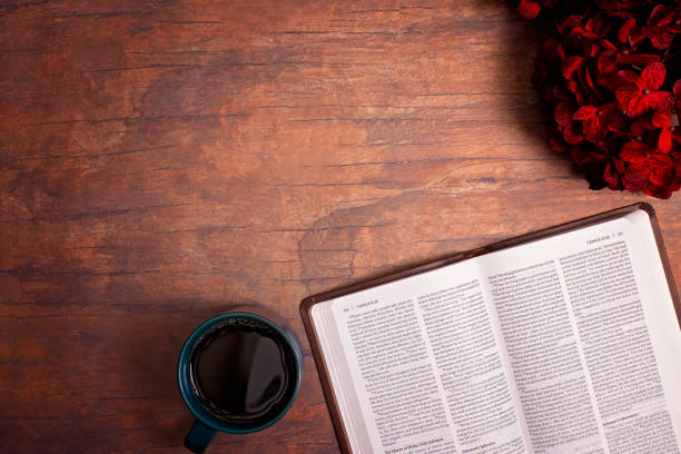 istock Personal Bible Study with Hot Coffee on a Distressed Red Wood Table 1319119424