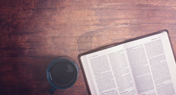 istock Personal Bible Study with Hot Coffee on a Distressed Red Wood Table 1319119469