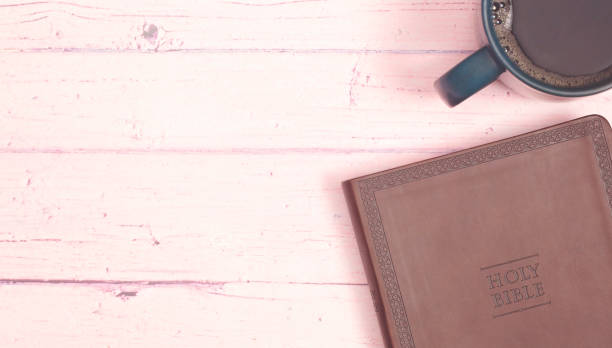 istock Personal Bible Study with a Cup of Hot Coffee on a Pink Table 1319119500