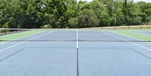 istock View looking over a tennis net into an empty court. 1319120849