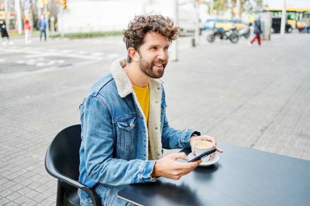 istock Man drinking coffee with mobile phone 1319123543