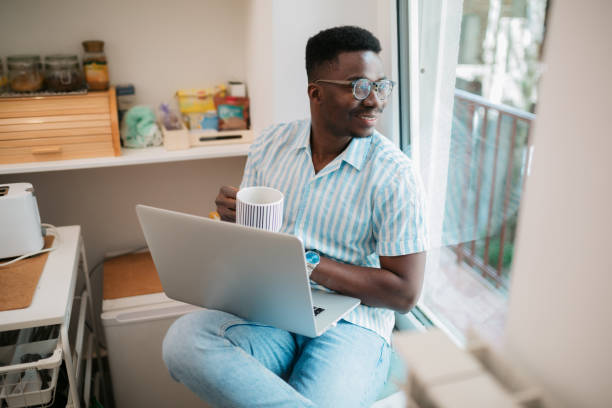 istock Handsome African American man working from home using a laptop 1319123922