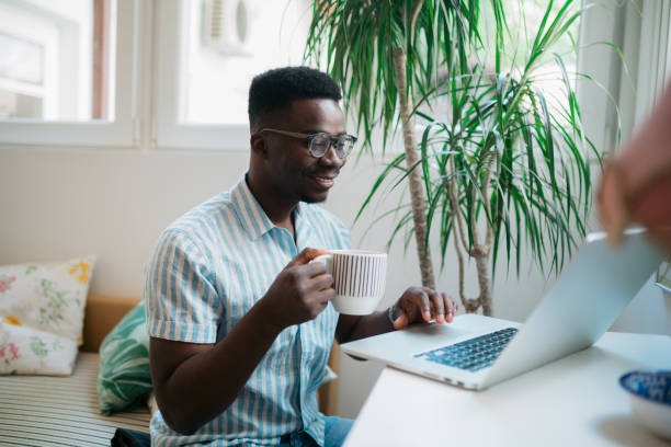 istock Handsome African American man working from home using a laptop 1319123964