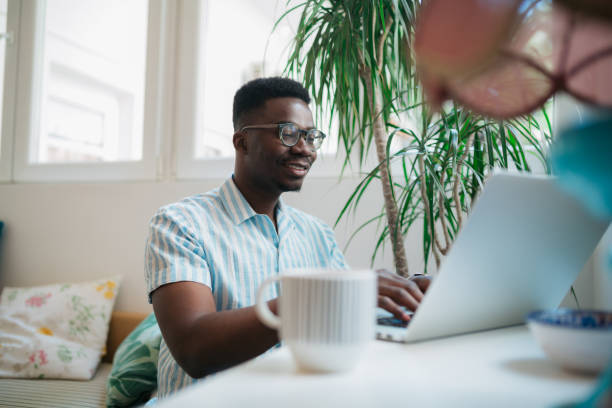 istock Handsome African American man working from home using a laptop 1319123989