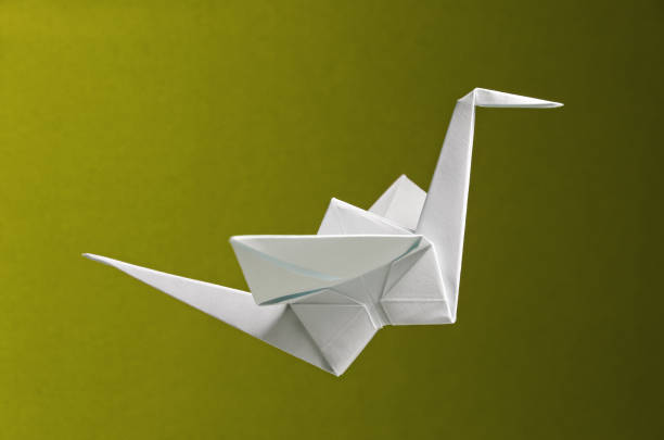 istock White Origami On Yellow Background 1319124874