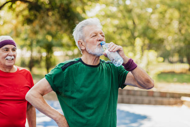 istock Active senior man on basketball field taking a break from sports activity 1319129422