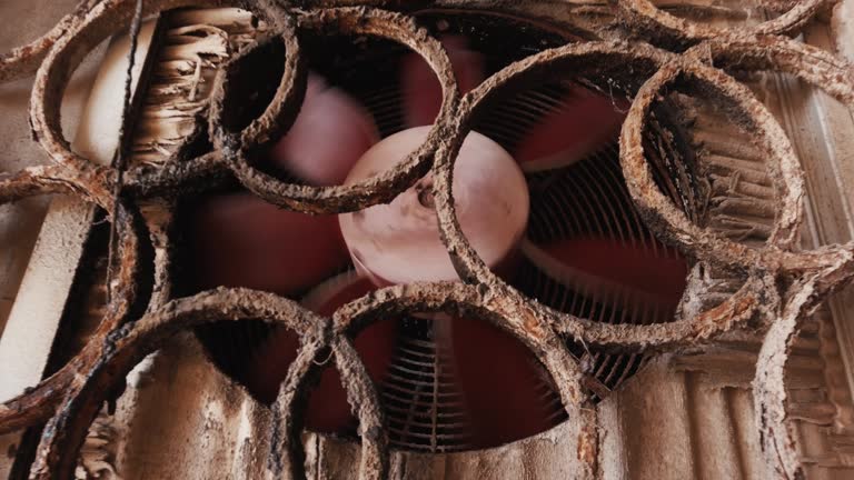 Old rusty air conditioner outdoors unit spinning in slow motion. Close up