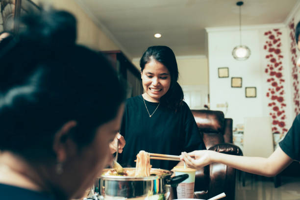 istock happy asian family talking while having lunch at dining table 1319139159