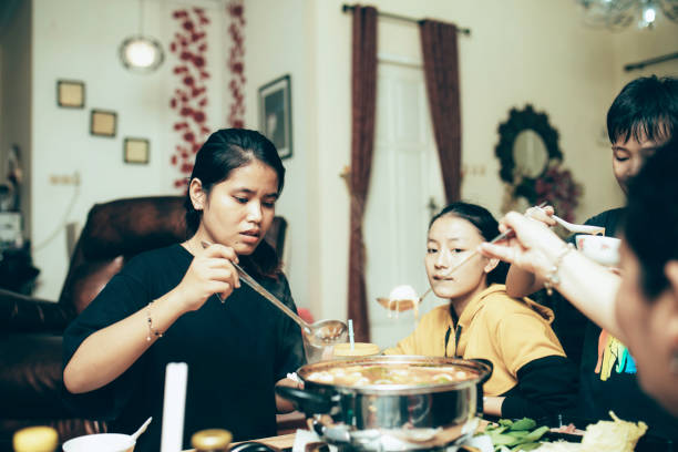 istock happy asian family talking while having lunch at dining table 1319139170