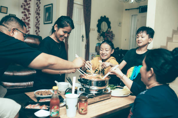 istock happy asian family talking while having lunch at dining table 1319139177