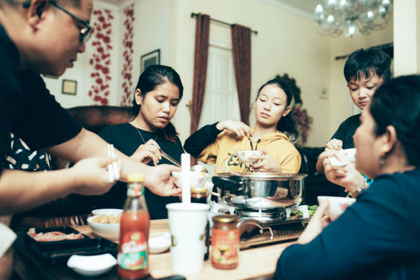 istock happy asian family talking while having lunch at dining table 1319139178