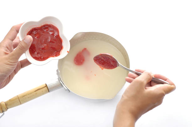 istock pour the strawberry jam into the cake batter - membuat adonan 1319140880