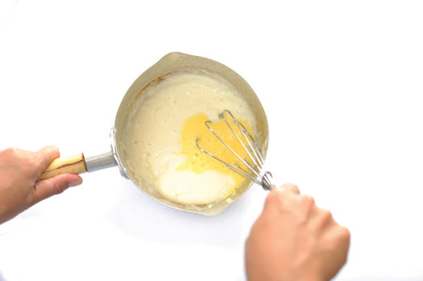istock beat the dough using an egg beaten - mengocok adonan 1319142547