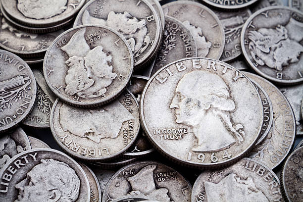 Pile of old Silver Dimes & Quarters A pile of old circulated worn collectible silver dimes and quarters. Could be used for silver bullion themes as well as coin collectible themes. coin collection stock pictures, royalty-free photos & images