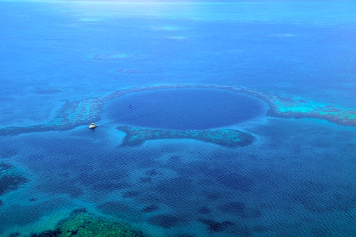 Watching and flying over  Blue hole off coast of Belize, Caribbean Ocean