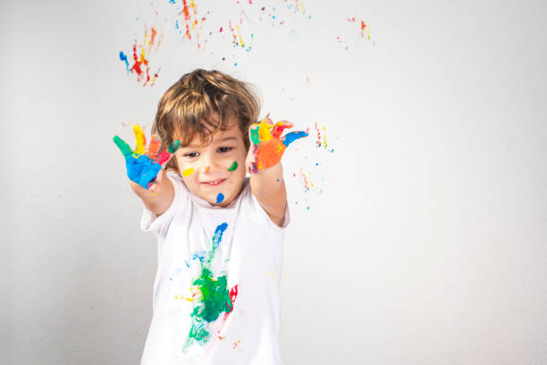 istock Boy Showing Colorful Paint on His Hands 1319147855