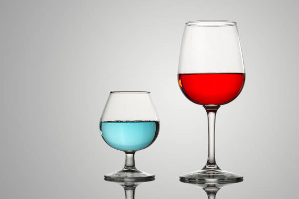 istock Crystal glasses with red and blue liquid or drinks 1319148618