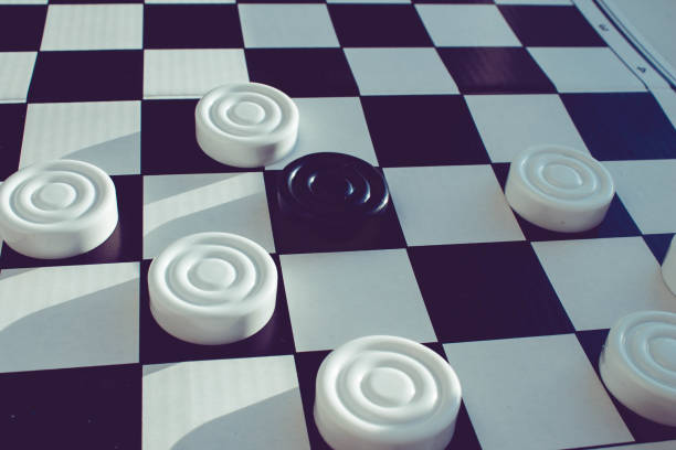 istock Board game of checkers. Black and white chips for the game. 1319150156