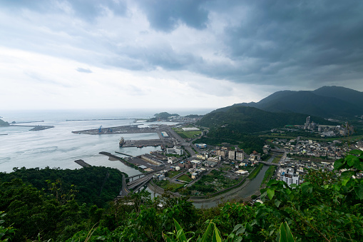Cloudy day overlook suao town with beautiful coast and house surrounded by mountain in Yilan, Taiwan.